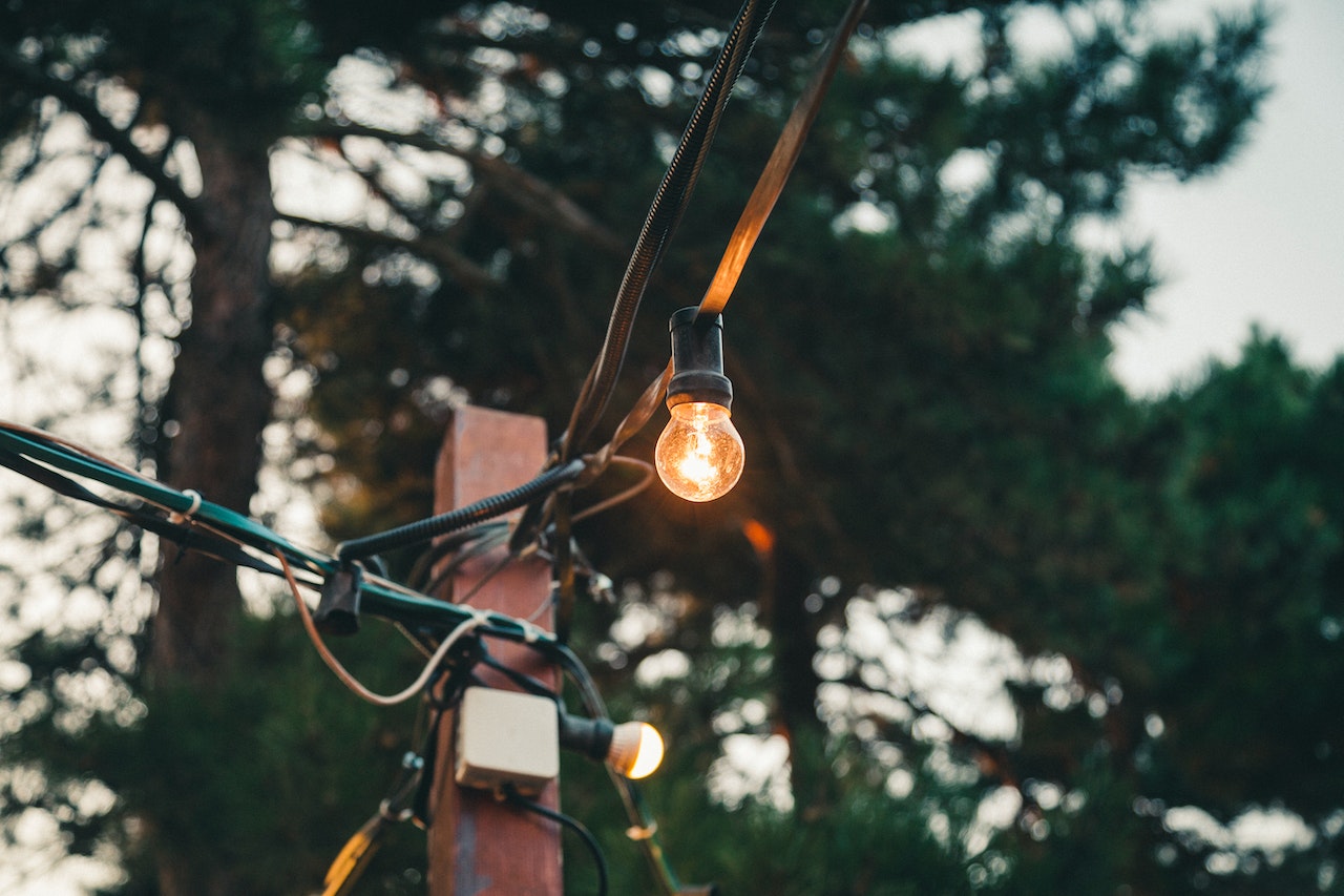 Solar light affixed to a wooden post outside